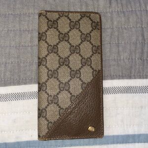 This is an authentic GUCCI Coated Canvas Monogram Checkbook